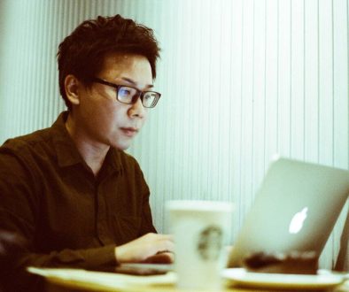 a man sitting at a table using a laptop computer seo agency team, digital marketing strategy, link building tools