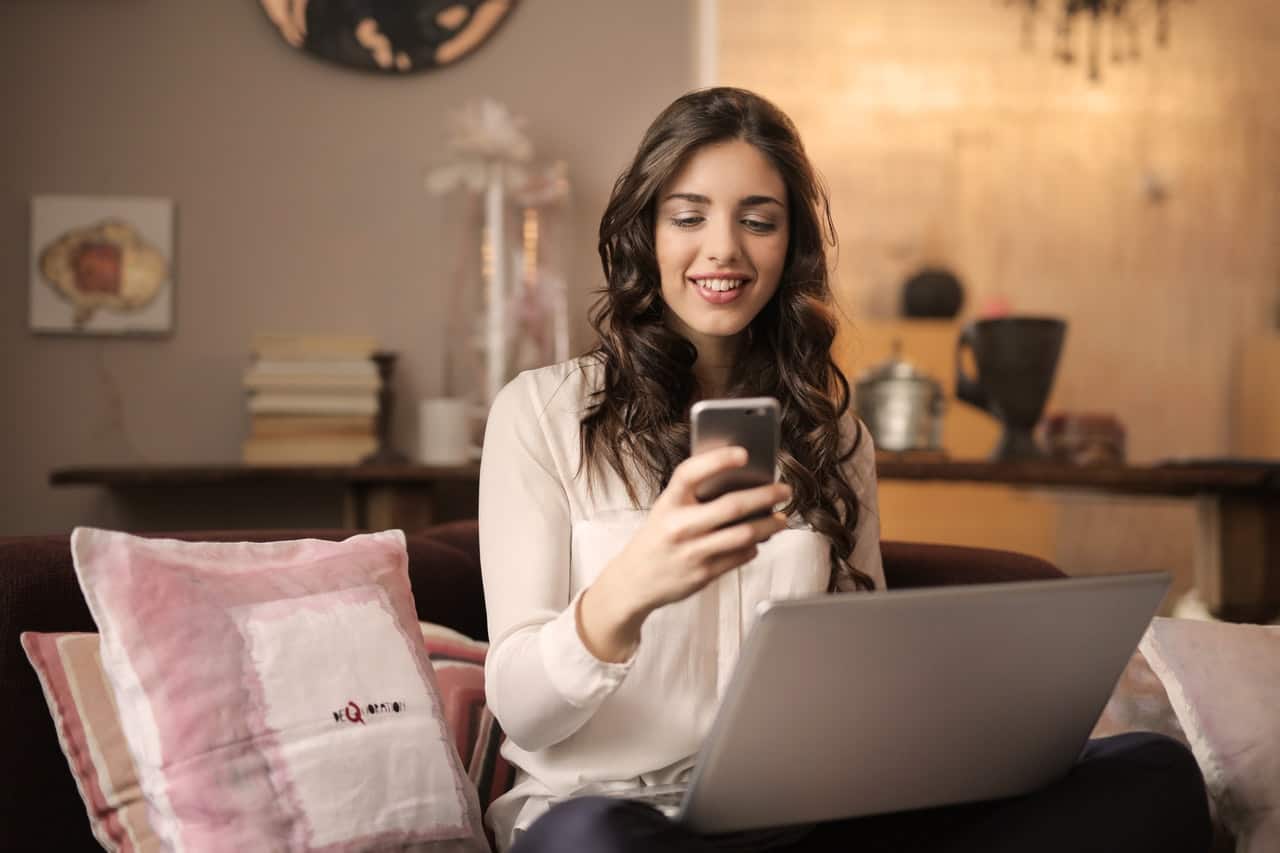 Woman looking at phone excited