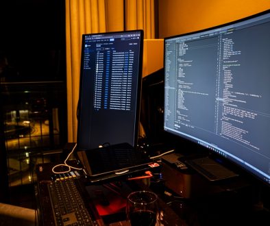 A man sitting in front of a computer monitor windows terminal, dism, command prompt
