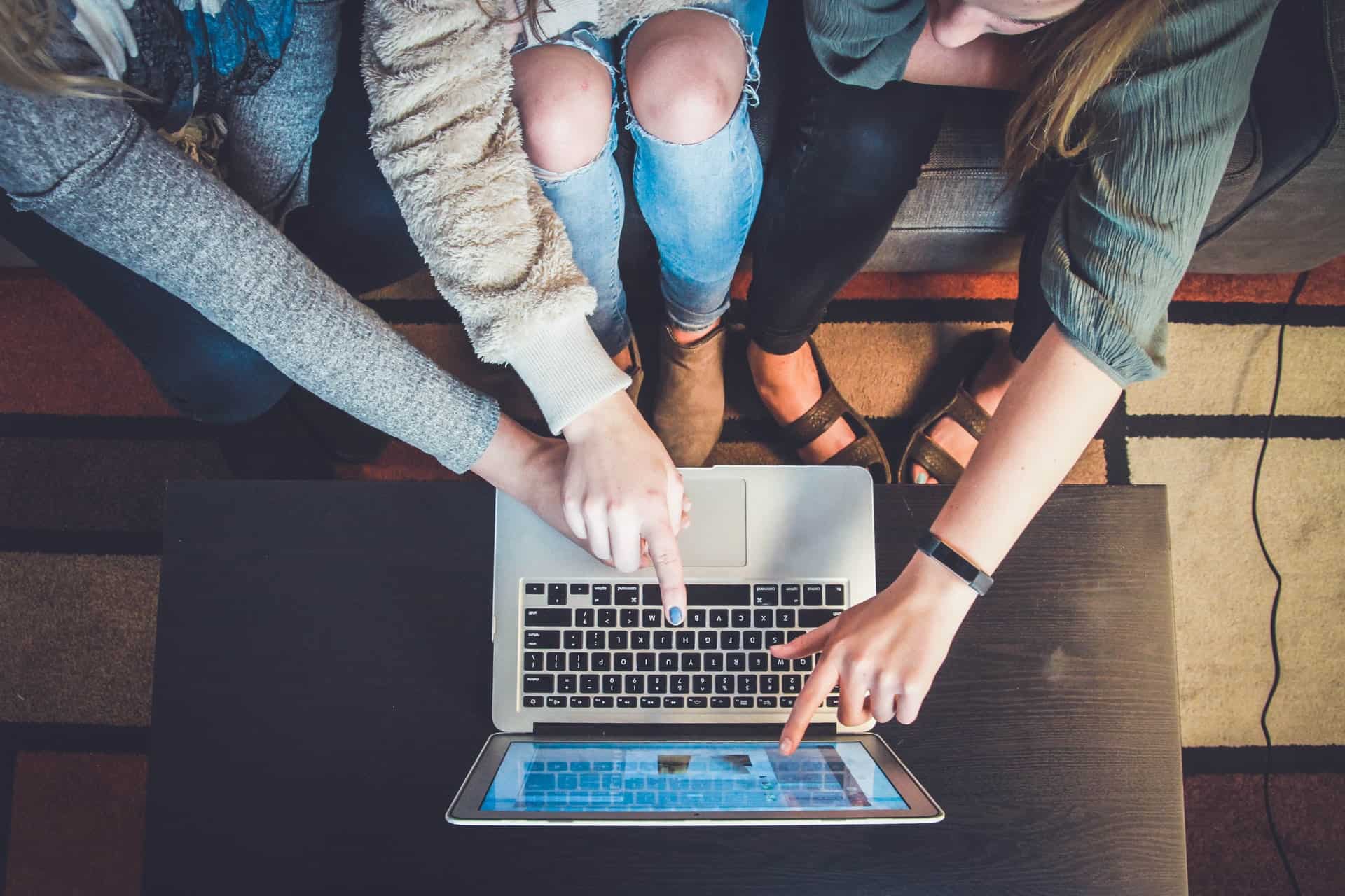 Girls pointing at laptop