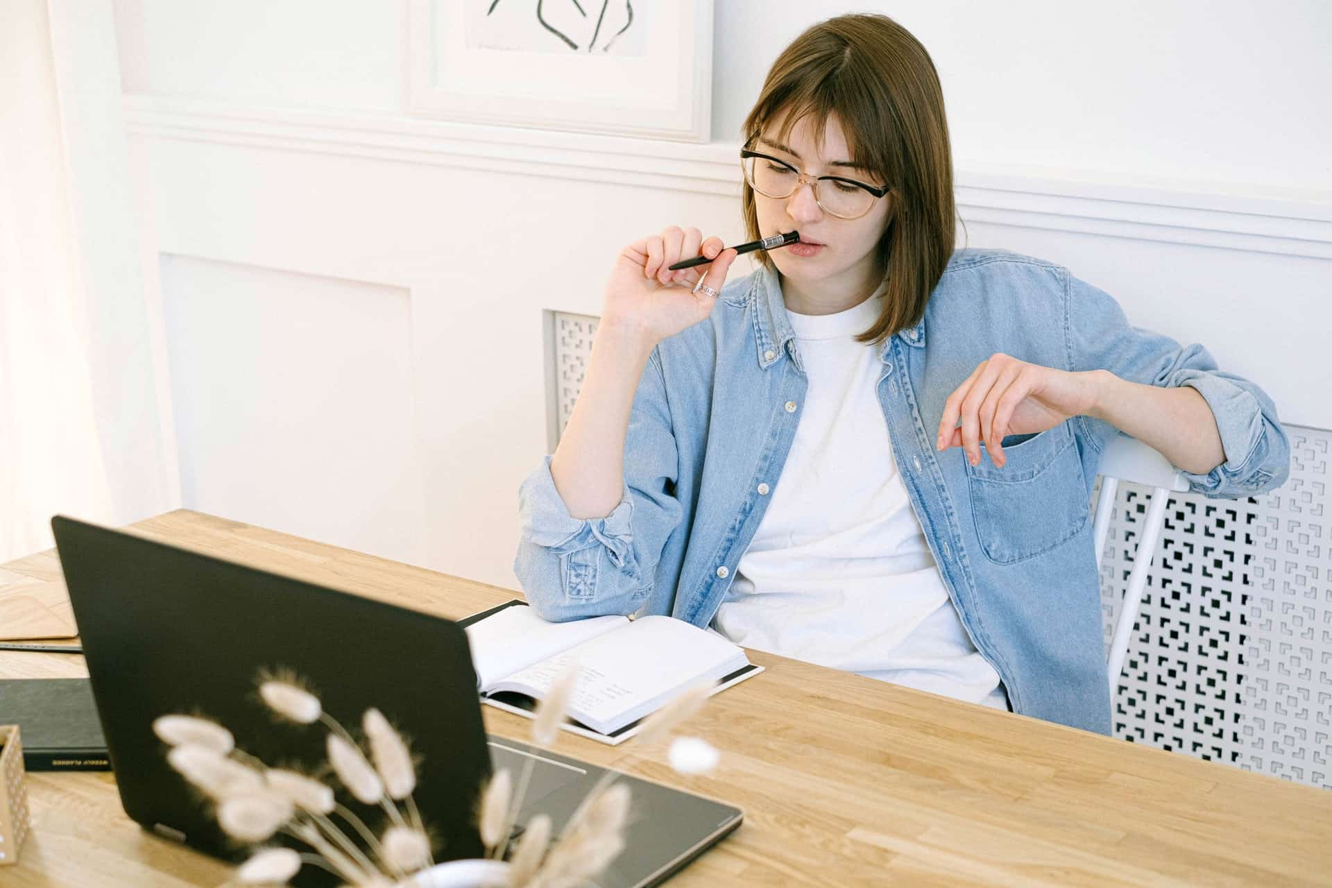 Woman thinking in front of laptop