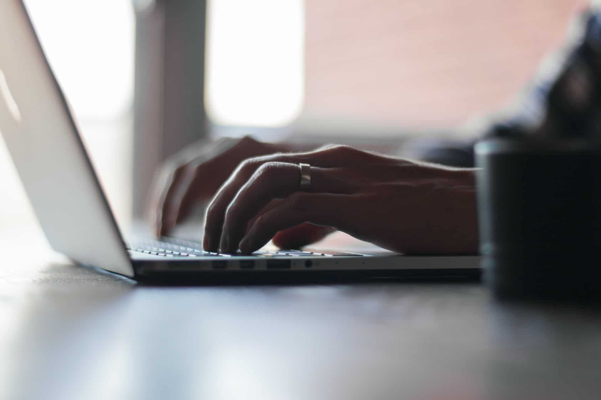 Woman typing on MacBook