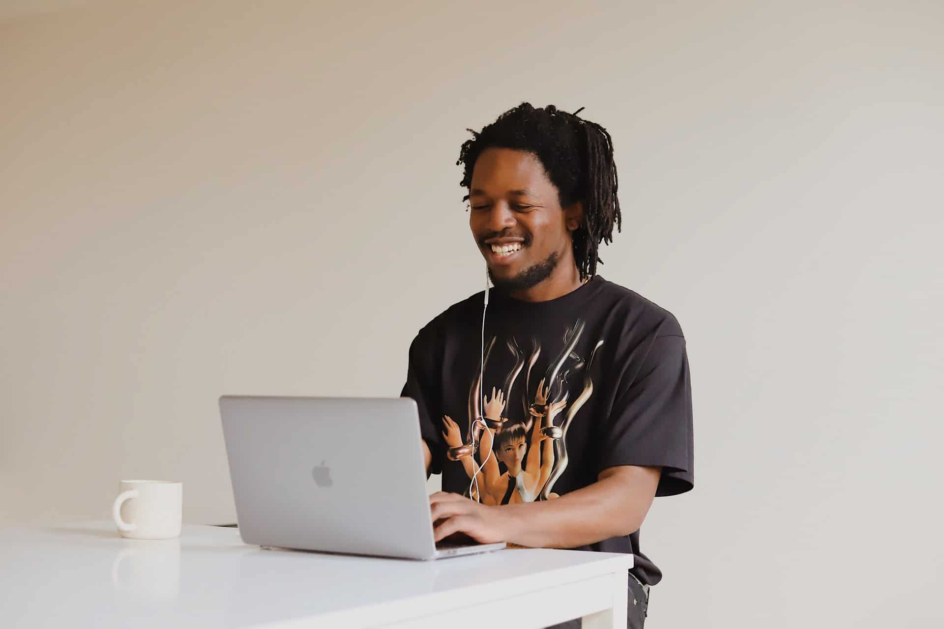 Man smiling at laptop