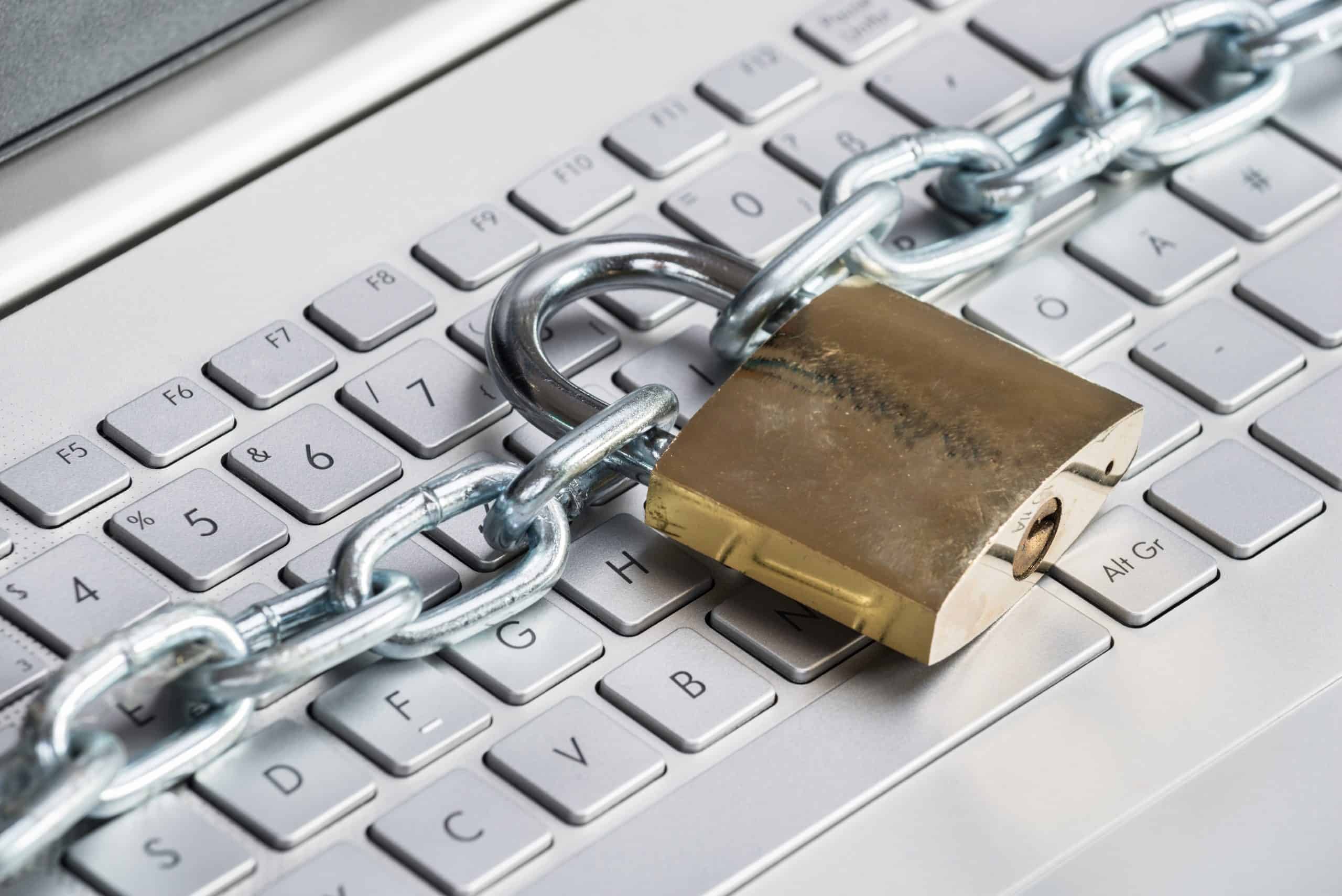 Padlock and chain on laptop