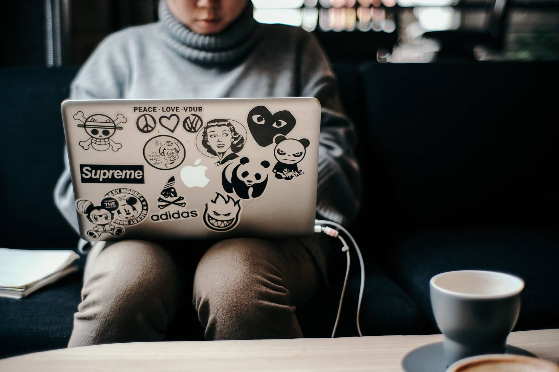 Woman working on laptop with coffee