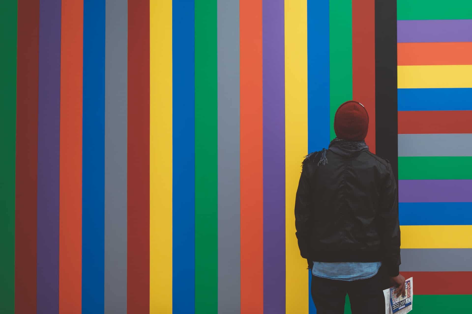 Man looking at colored wall