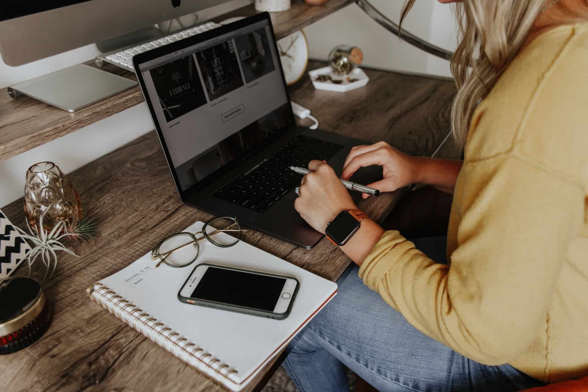 Woman writing on laptop