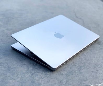 a cell phone on a table macbook pro swollen battery