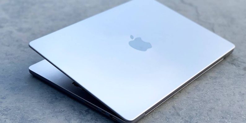 a cell phone on a table macbook pro swollen battery