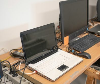 a desk with two laptops and a keyboard on it laptop docking station, tech workspace, minimalist office setup