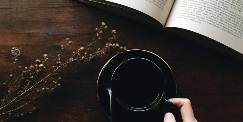 round black metal container near white book open ai reading notes, editing content, brainstorming ideas
