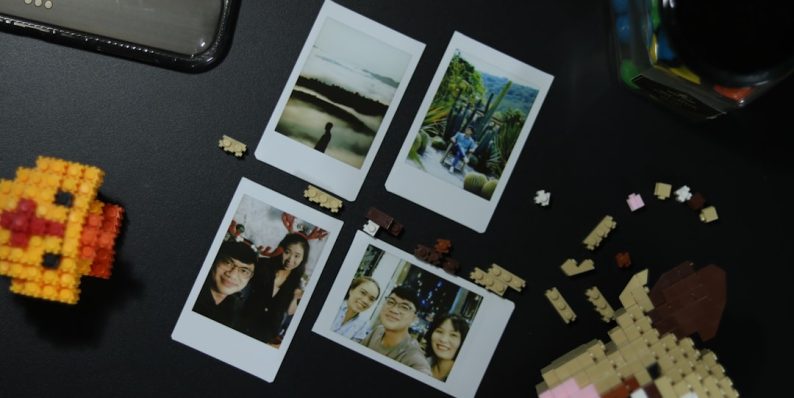 a black table topped with pictures of people and legos fotor app, editing tools, professional collage