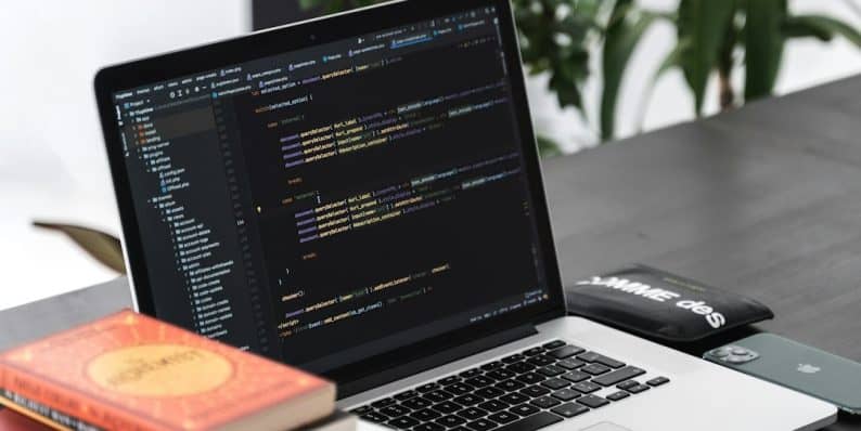 macbook pro on black wooden table wordpress admin, cpt debug, php code editor