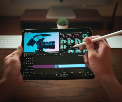 person holding black tablet computer iphone video editing, professional mobile editor, lumafusion