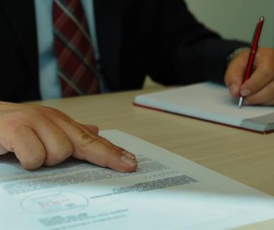 a man in a suit signing a document with a pen property manager, vendor meeting, agreement document