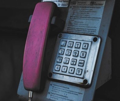 An old style phone is attached to a wall tangoe dashboard, expense tracking, telecom management