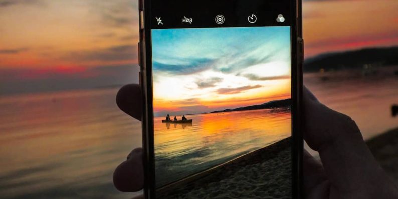 person holding black iphone 5 inshot app, mobile editing, video transitions