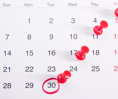 a calendar with red push buttons pinned to it iphone software update, ios new version, calendar bug fix