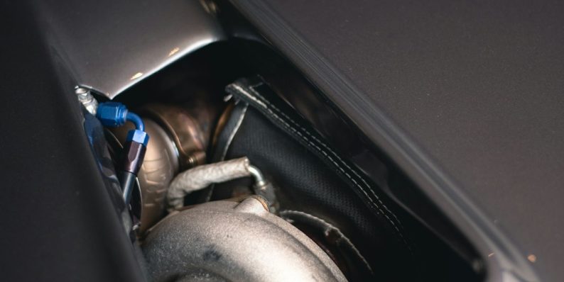 a close up of a car's exhaust system car engine, ignition system, wires, spark plugs