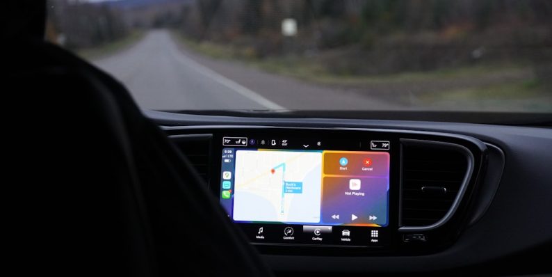 a man driving a car with a gps device in his hand device manager, windows settings, driver update