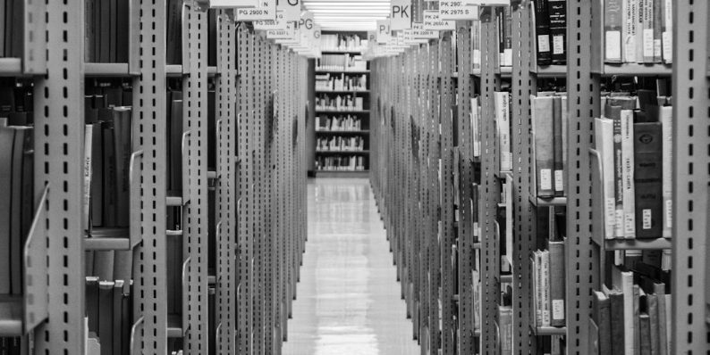 Library shelves stretch into the distance. large files, storage management, macbook finder