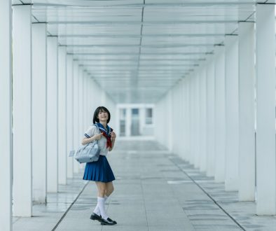 Schoolgirl poses in a white hallway. lookism, korean anime, netflix