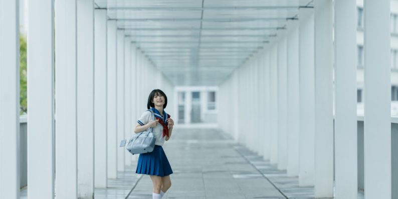 Schoolgirl poses in a white hallway. lookism, korean anime, netflix