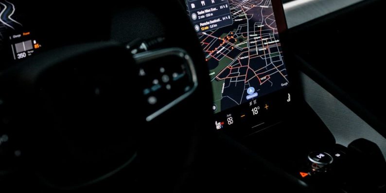 the dashboard of a car with a gps device device manager, windows settings, driver update