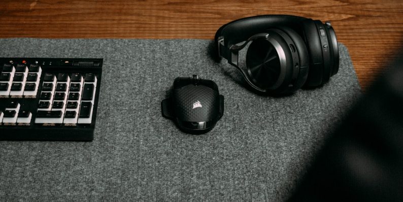 a black headphones on a black surface controller buttons, fortnite keybinds, gaming controller