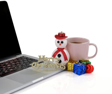 a laptop and a cup of coffee ecommerce training, online grocery, happy employees