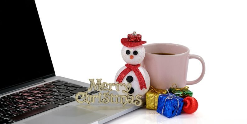 a laptop and a cup of coffee ecommerce training, online grocery, happy employees