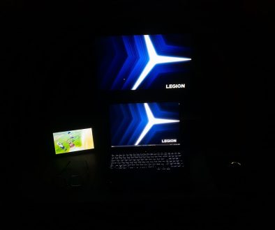 A laptop computer sitting on top of a desk acer swift x gaming setup, laptop with lights, gamer playing