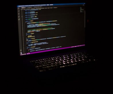 a laptop computer sitting on top of a table developer computer code ai