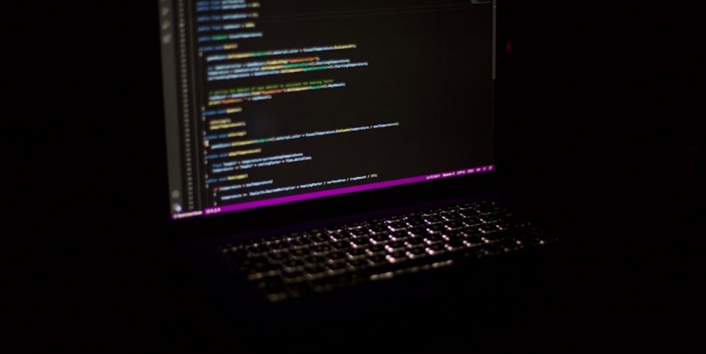 a laptop computer sitting on top of a table developer computer code ai