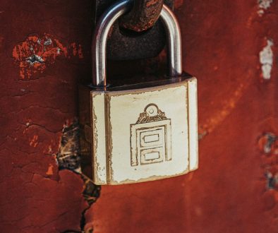 a padlock attached to a rusted red wall ssl encryption, keberos authentication, certificate trust