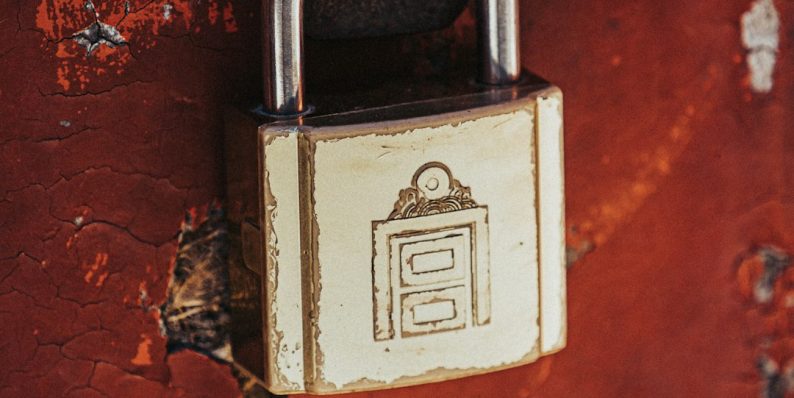 a padlock attached to a rusted red wall ssl encryption, keberos authentication, certificate trust
