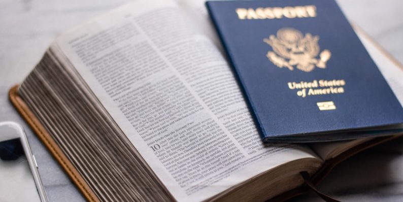 a passport sitting on top of an open book student transcripts, study abroad, transfer documents