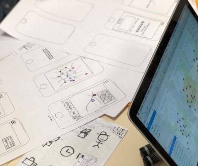 a person sitting at a table with a tablet canva app, logo editing, startup teamwork