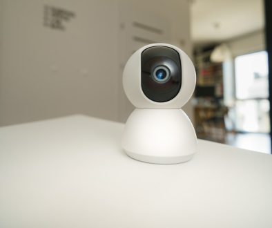 A small camera sitting on top of a white table windows camera, webcam app, pc camera tool