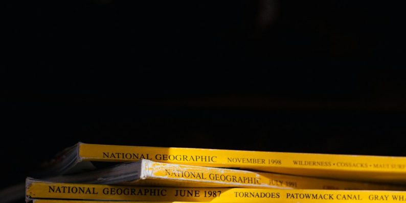 a stack of books sitting on top of a wooden table git status gitignore issue ignored files