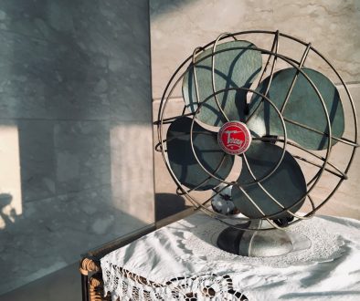 black desk fan on white and black floral table cloth ps5 overheating fan vent console