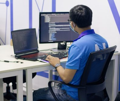 boy in blue t-shirt sitting on black office rolling chair in front of computer software maintenance, patch management, system security