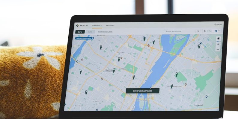 a laptop with a map on the screen tracking apps, delivery management, smartphone dashboard