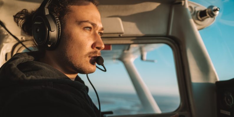 a man wearing headphones sitting in the cockpit of a plane microsoft copilot, salesforce crm, ai assistant a man wearing headphones sitting in the cockpit of a plane microsoft copilot, salesforce crm, ai assistant