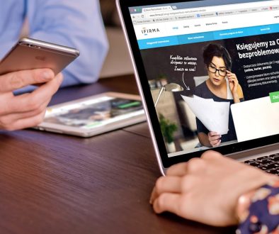 a person on a cell phone and a laptop on a table mercari app, online selling, ecommerce fees