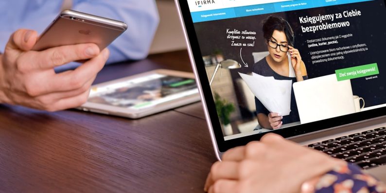 a person on a cell phone and a laptop on a table mercari app, online selling, ecommerce fees