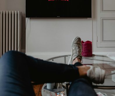 man lying on sofa infront of TV frustrated viewer popcorn couch netflix man lying on sofa infront of TV frustrated viewer popcorn couch netflix