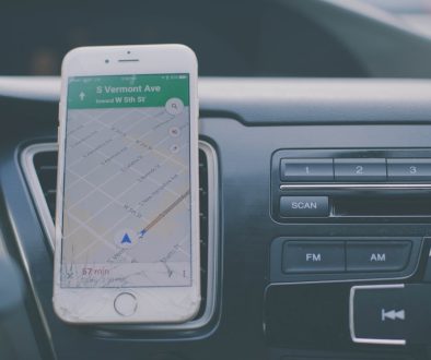 silver iPhone 6 on front of car aircon tracking apps, delivery management, smartphone dashboard