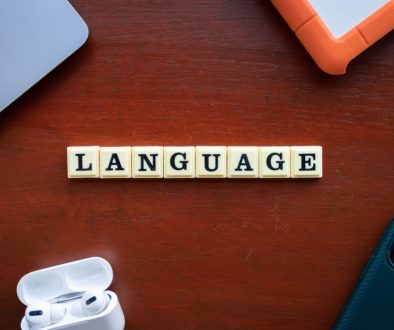 the word language spelled with scrabble tiles on a table translation tools, bilingual people, language app