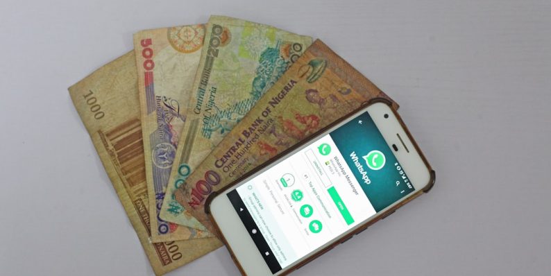 white Android smartphone beside banknotes venmo app phone friends money